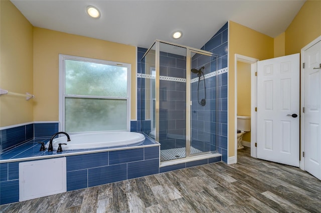 bathroom featuring a garden tub, wood finished floors, toilet, recessed lighting, and a shower stall