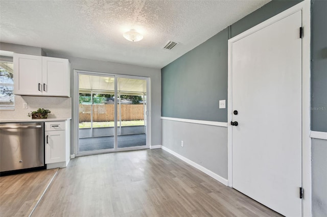 4940 Rosedale Ln, Holiday, FL 34690 - kitchen with light wood-type flooring, dishwasher, and white cabinets
