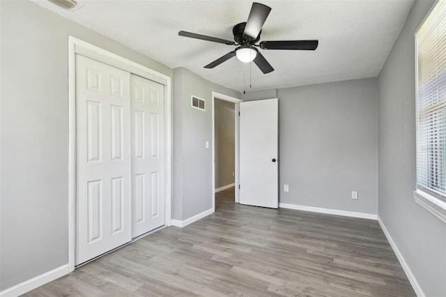 4940 Rosedale Ln, Holiday, FL 34690 - unfurnished bedroom with a closet, wood finished floors, and visible vents