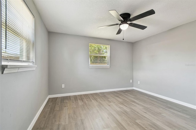 4940 Rosedale Ln, Holiday, FL 34690 - empty room featuring baseboards, ceiling fan, a textured ceiling, and wood finished floors
