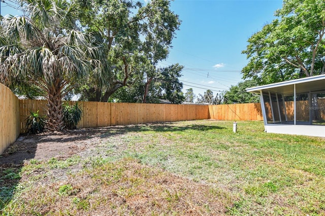 4940 Rosedale Ln, Holiday, FL 34690 - view of yard featuring a fenced backyard and a sunroom