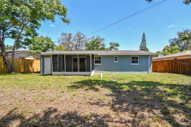 4940 Rosedale Ln, Holiday, FL 34690 - back of property featuring a yard, a fenced backyard, and a sunroom