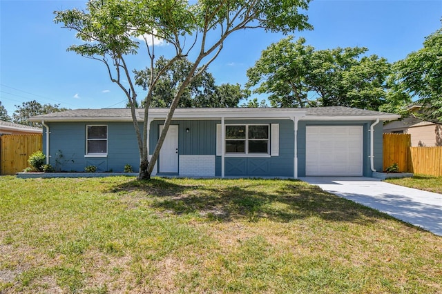 4940 Rosedale Ln, Holiday, FL 34690 - single story home featuring fence, an attached garage, driveway, and a front lawn