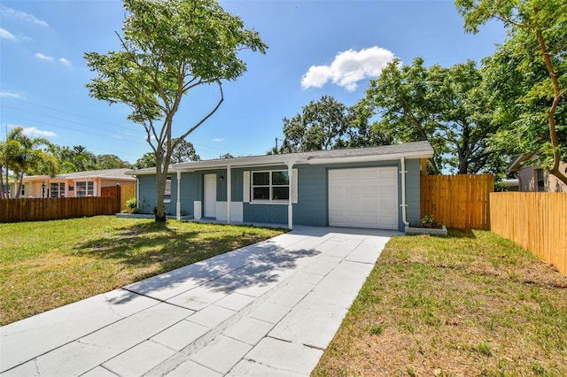 4940 Rosedale Ln, Holiday, FL 34690 - ranch-style home with an attached garage, a front lawn, fence, and concrete driveway