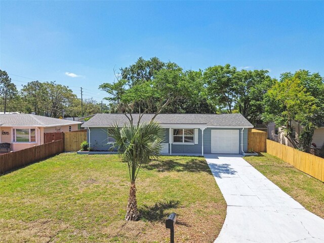 4940 Rosedale Ln, Holiday, FL 34690 - ranch-style house with a garage, a front lawn, fence, and driveway