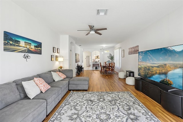 19129 Lake Audubon Dr, Tampa, FL 33647 - living room featuring visible vents, arched walkways, ceiling fan, and wood finished floors