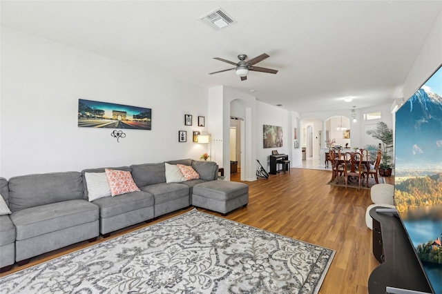 19129 Lake Audubon Dr, Tampa, FL 33647 - living room with arched walkways, a ceiling fan, visible vents, and wood finished floors