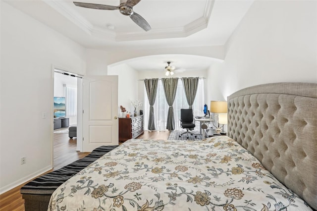 19129 Lake Audubon Dr, Tampa, FL 33647 - bedroom featuring arched walkways, multiple windows, and wood finished floors