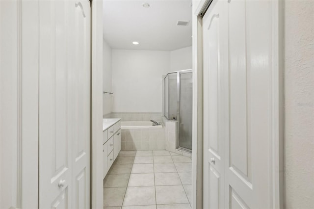 19129 Lake Audubon Dr, Tampa, FL 33647 - bathroom with a bath, visible vents, tile patterned flooring, a stall shower, and vanity