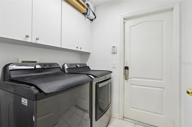 19129 Lake Audubon Dr, Tampa, FL 33647 - washroom with cabinet space, light tile patterned flooring, and washing machine and dryer
