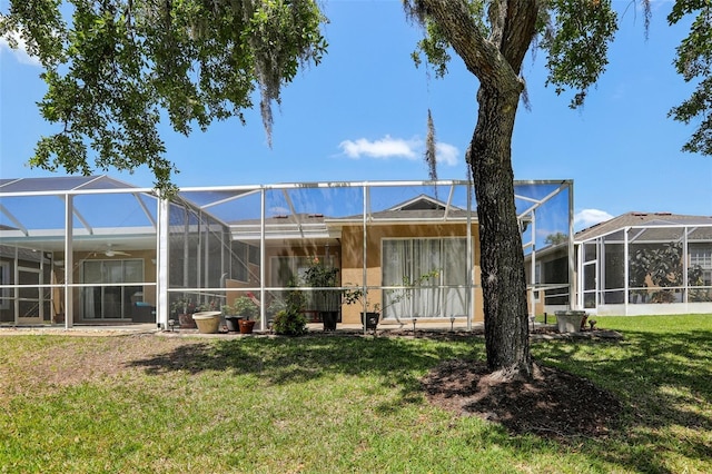19129 Lake Audubon Dr, Tampa, FL 33647 - rear view of property featuring a lawn, a ceiling fan, and a lanai