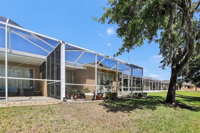 19129 Lake Audubon Dr, Tampa, FL 33647 - exterior space featuring a lawn, glass enclosure, and a patio area