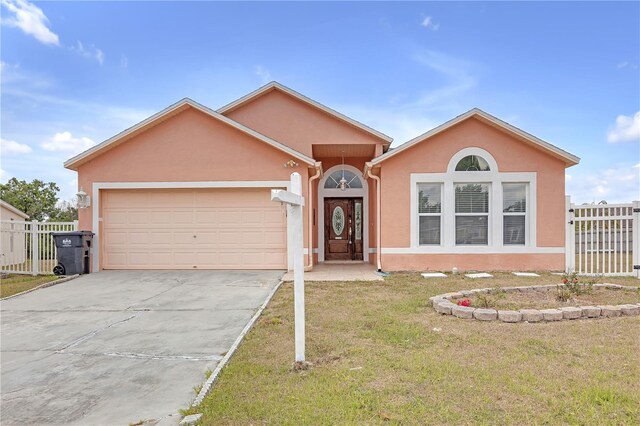 4617 Horseshoe Pick Ln, Valrico, FL 33594 - ranch-style home featuring stucco siding, an attached garage, and driveway
