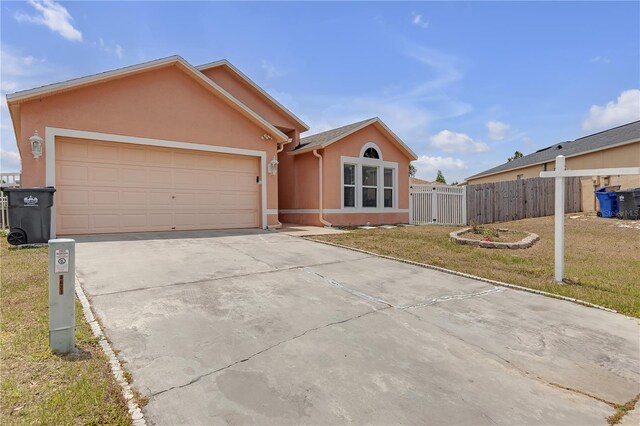 4617 Horseshoe Pick Ln, Valrico, FL 33594 - ranch-style home featuring stucco siding, driveway, and a garage