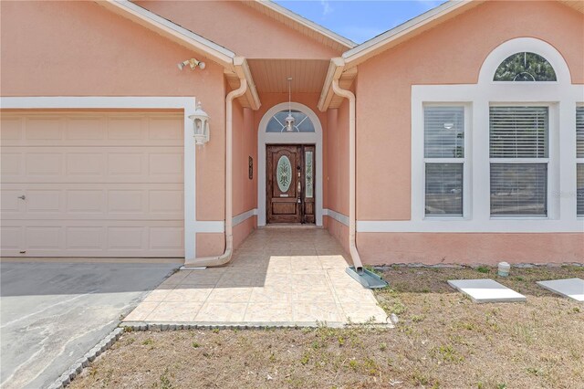 4617 Horseshoe Pick Ln, Valrico, FL 33594 - entrance to property featuring stucco siding, driveway, and a garage