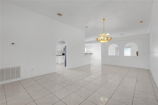 4617 Horseshoe Pick Ln, Valrico, FL 33594 - empty room featuring a chandelier, light tile patterned floors, and arched walkways