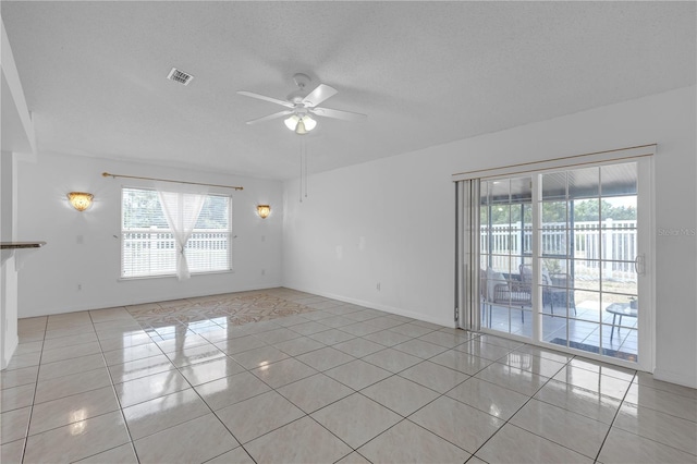 4617 Horseshoe Pick Ln, Valrico, FL 33594 - unfurnished room with ceiling fan, healthy amount of natural light, light tile patterned floors, and a textured ceiling
