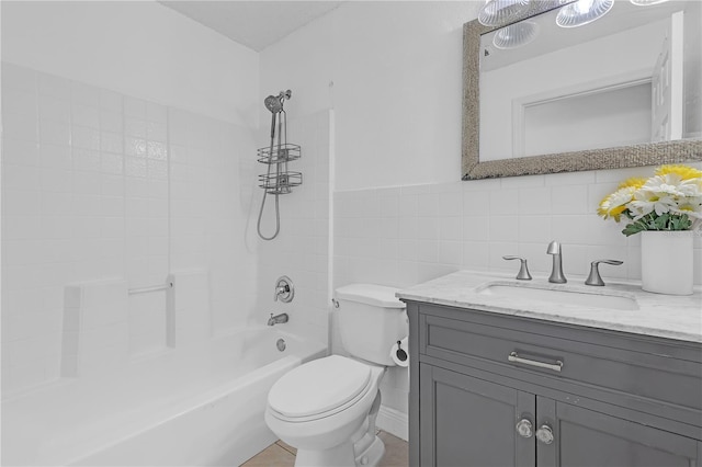 4617 Horseshoe Pick Ln, Valrico, FL 33594 - bathroom with toilet, vanity, tile walls, and washtub / shower combination