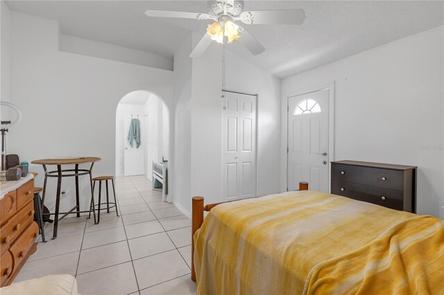 4617 Horseshoe Pick Ln, Valrico, FL 33594 - bedroom with arched walkways, light tile patterned floors, vaulted ceiling, a closet, and a ceiling fan