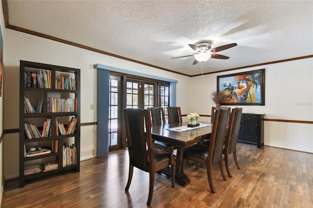 dining room with crown molding, a textured ceiling, a ceiling fan, and wood finished floors