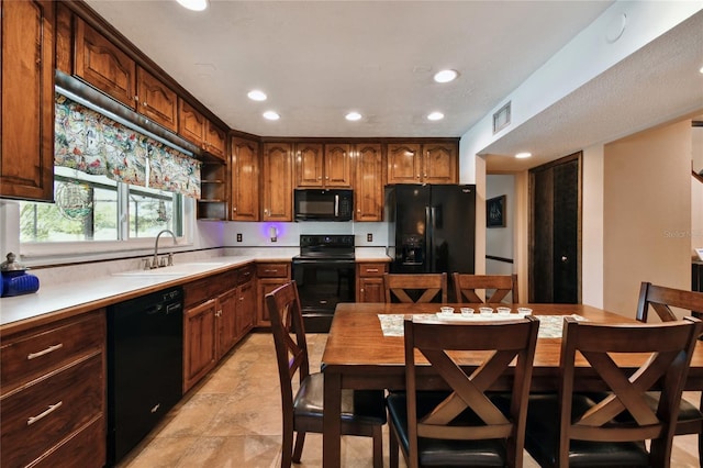 kitchen with recessed lighting, visible vents, a sink, black appliances, and light countertops