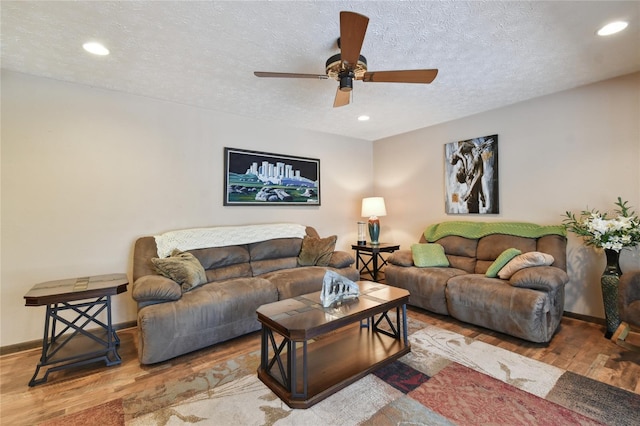 living room with ceiling fan, recessed lighting, a textured ceiling, and wood finished floors