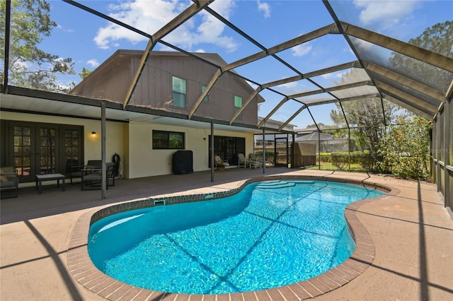 outdoor pool featuring a patio and french doors