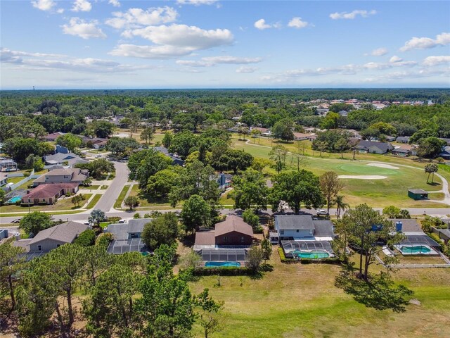 birds eye view of property with golf course view and a residential view