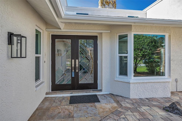 833 Lakeside Ter, Palm Harbor, FL 34683 - view of exterior entry with french doors and stucco siding
