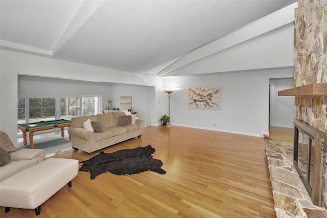833 Lakeside Ter, Palm Harbor, FL 34683 - living area with billiards, a fireplace, vaulted ceiling, wood finished floors, and baseboards