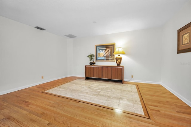 833 Lakeside Ter, Palm Harbor, FL 34683 - spare room featuring light wood-style floors, baseboards, and visible vents