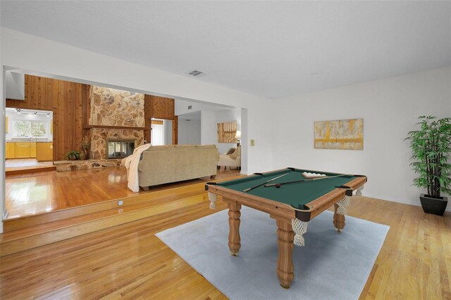 833 Lakeside Ter, Palm Harbor, FL 34683 - rec room with wooden walls, a fireplace, billiards, wood finished floors, and visible vents