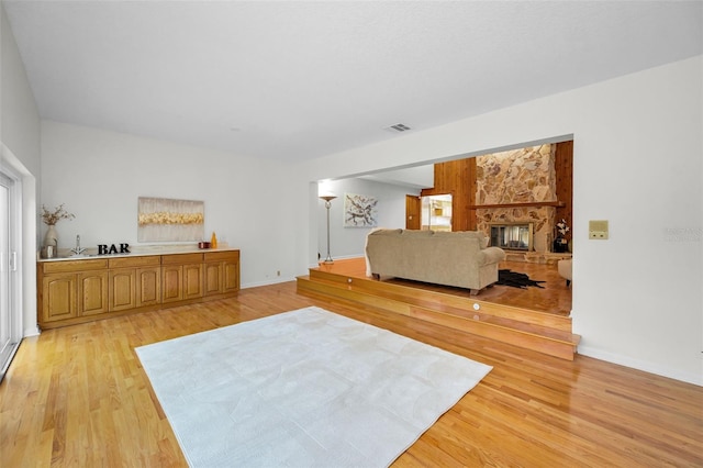 833 Lakeside Ter, Palm Harbor, FL 34683 - interior space with a fireplace, baseboards, visible vents, and light wood-style floors