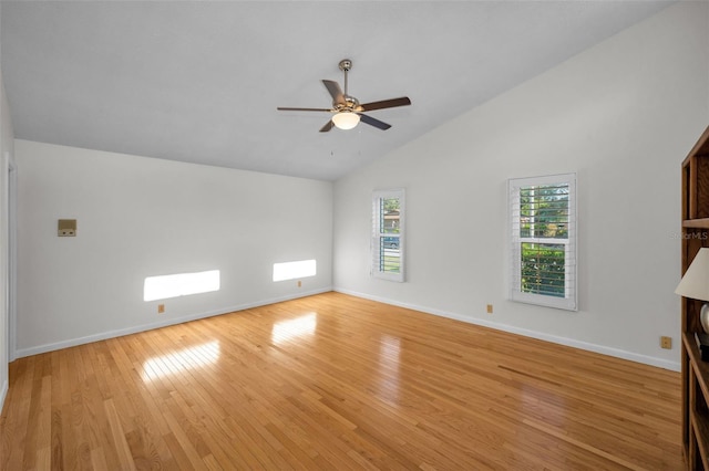 833 Lakeside Ter, Palm Harbor, FL 34683 - unfurnished living room with light wood-style floors, baseboards, ceiling fan, and vaulted ceiling