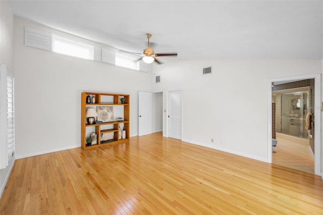 833 Lakeside Ter, Palm Harbor, FL 34683 - interior space featuring light wood-style floors, a towering ceiling, a ceiling fan, and visible vents