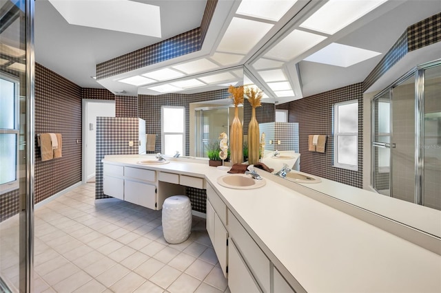 833 Lakeside Ter, Palm Harbor, FL 34683 - bathroom featuring tile patterned flooring, a sink, double vanity, and a shower stall