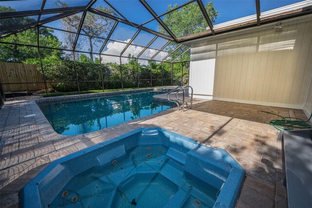 833 Lakeside Ter, Palm Harbor, FL 34683 - view of swimming pool featuring a fenced in pool, glass enclosure, an in ground hot tub, and a patio