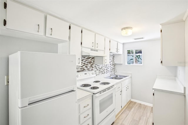 kitchen with a sink, light wood-type flooring, white appliances, under cabinet range hood, and decorative backsplash