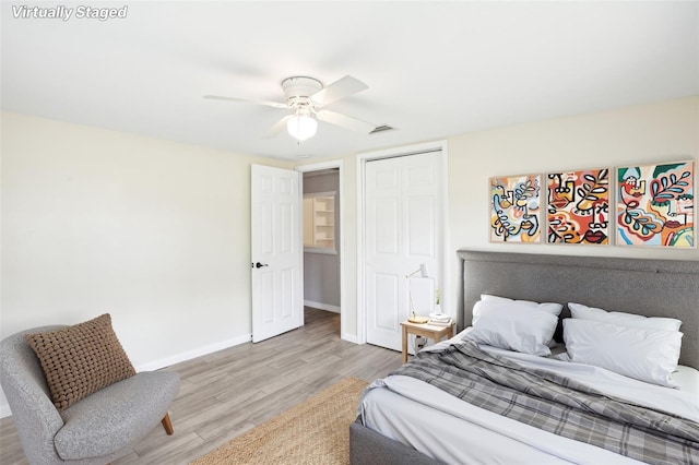 bedroom featuring a closet, visible vents, ceiling fan, baseboards, and light wood-style floors