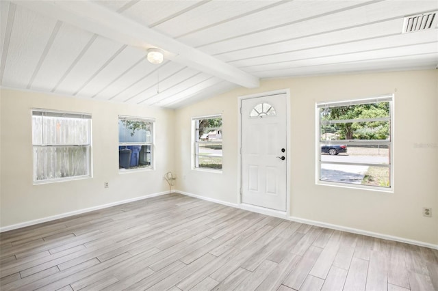 entryway with wood finished floors, vaulted ceiling with beams, plenty of natural light, visible vents, and baseboards