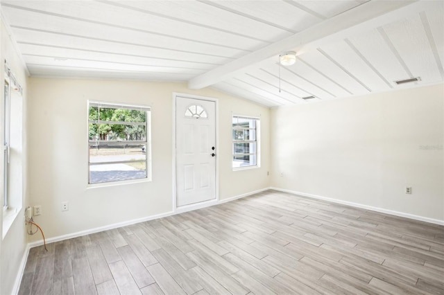 foyer entrance featuring baseboards, light wood finished floors, visible vents, and vaulted ceiling with beams