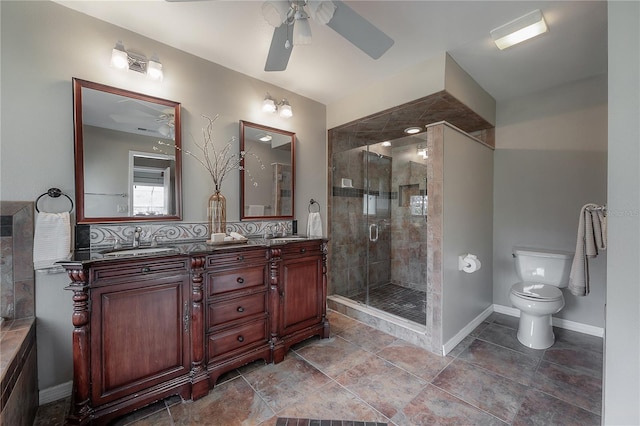 full bathroom featuring double vanity, a sink, a ceiling fan, and a shower stall
