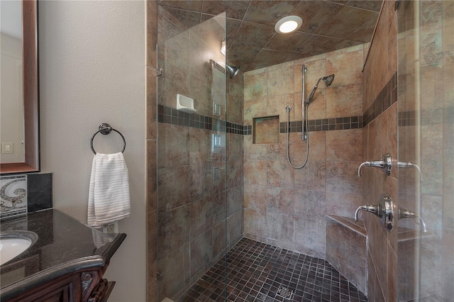 bathroom with vanity and tiled shower
