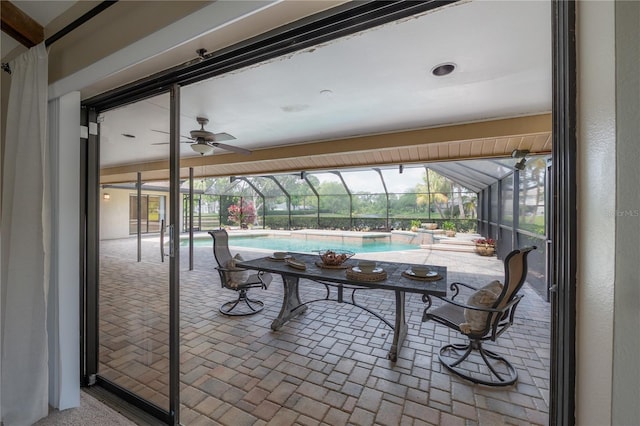 view of patio / terrace featuring glass enclosure and an outdoor pool