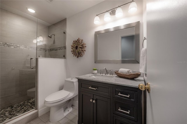 full bath with vanity, tile patterned floors, a stall shower, and toilet