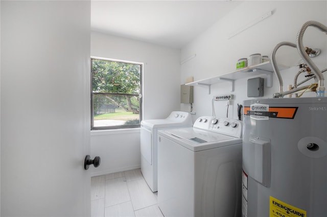 clothes washing area with laundry area, water heater, and independent washer and dryer