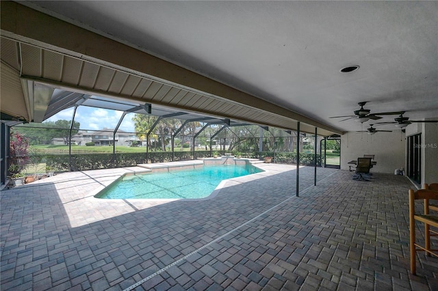 pool with ceiling fan, a patio area, and glass enclosure