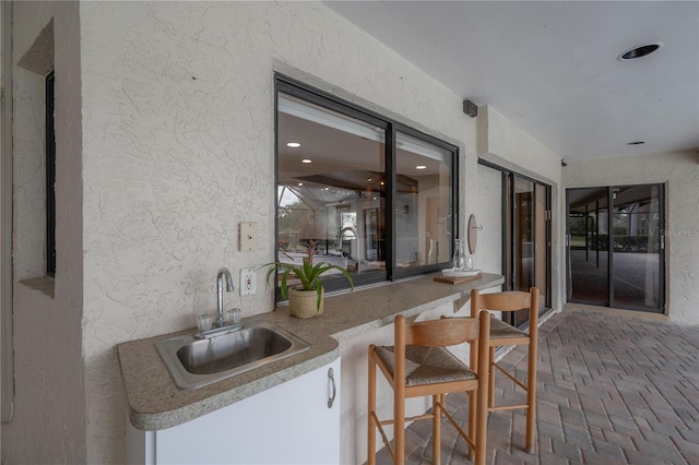 view of patio featuring a sink and an outdoor kitchen