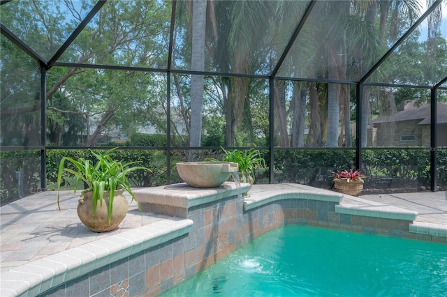 outdoor pool featuring a lanai and a patio area