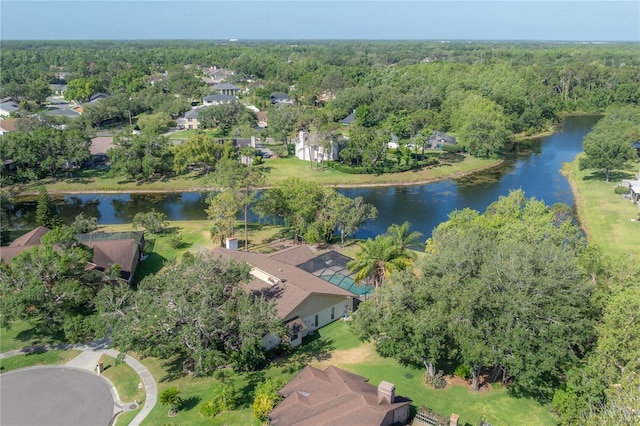 drone / aerial view featuring a residential view, a water view, and a forest view